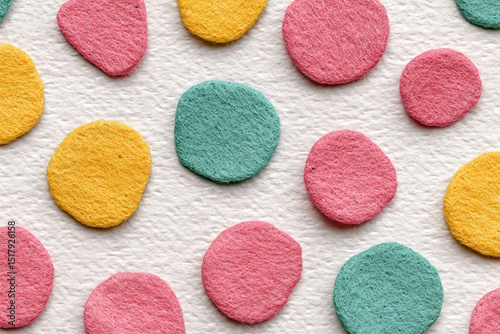 Colorful confetti circles dance on a textured canvas, evoking playful whispers of Holi joy and Dia de los Muertos vibrancy