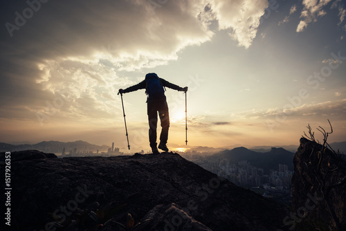 Canvas Print Successful backpacker enjoy the view stand on the cliff edge in hong kong