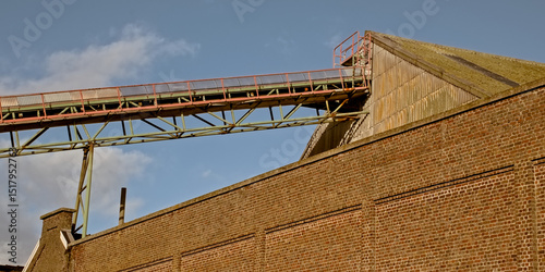  Detail of a conveyor belt coming out of an industrial buidling in the old docks of the port of Ghent, Belgium 