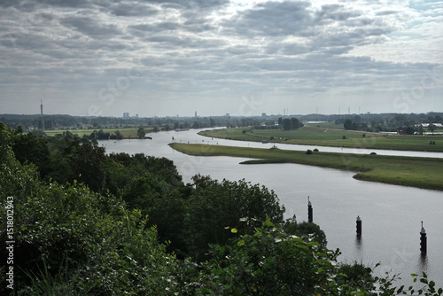 View on the river Lower Rhine (Nederrijn) and far away the city of Arnhem, in the Netherlands in June 2025
