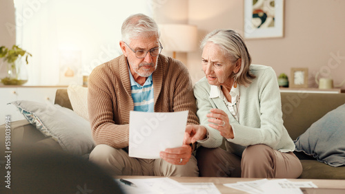 Senior couple, finance and discussion with documents on sofa for budget, expenses or bills at home. Elderly, man and woman with paperwork or stress for financial crisis, mortgage debt or pension fail