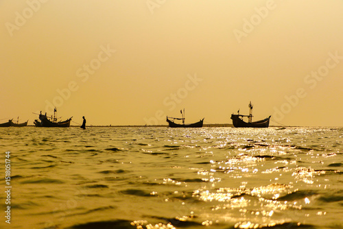 traditional fishing boats at sunset. cox's bazar, bay of bengal, Bangladesh