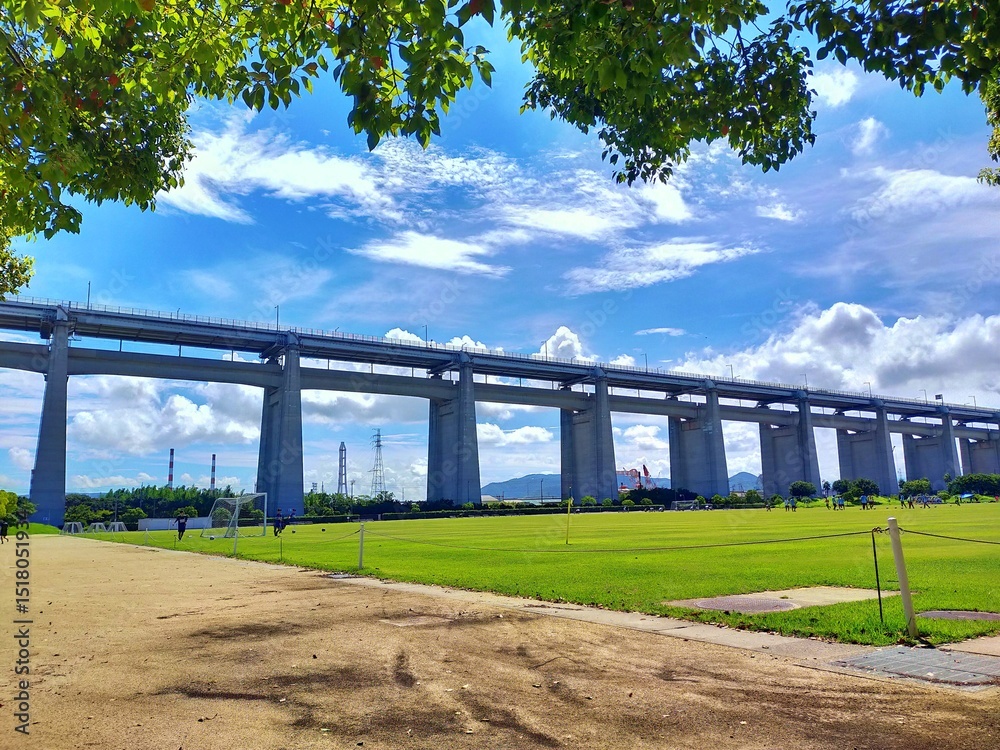 Fototapeta premium 夏空にそびえる瀬戸大橋と緑の広場