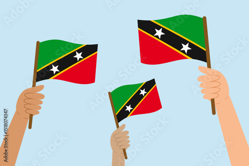 Diverse people hands raising flags of Saint Kitts and Nevis. Vector illustration of Saint Kitts and Nevis flags in flat style on blue background.