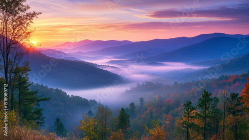 Sunset over mountain peaks with fog in the valley. Background for themes about nature and traveling.