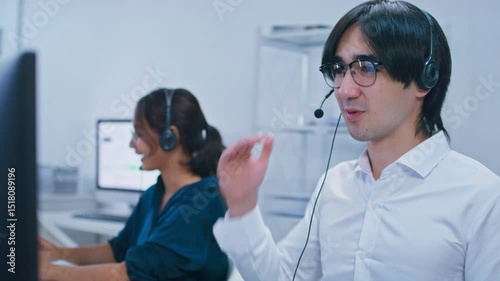 Customer care support at Call center office. Confident Diverse Customer Service Operators Wearing headset Working on Computer talking to client for telemarketing, CRM and helpdesk support in office.