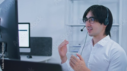 Customer service support agent male working on computer with headset talking to client, online consultant, CRM marketing, customer support, helping and Customer representative in call center office.