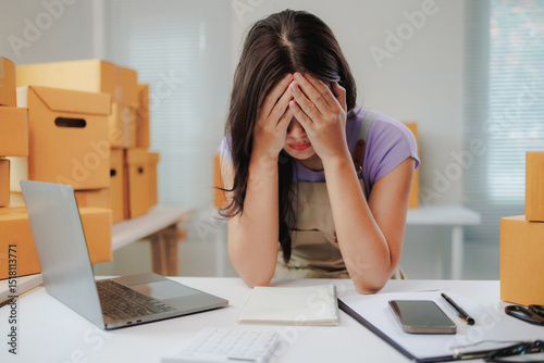 Bilde på lerret Young asian woman running a small business feeling stressed and tired after chec
