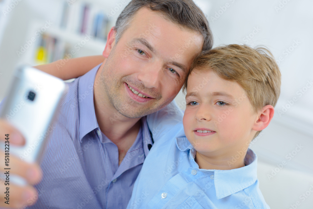 Obraz premium Father and son taking photograph of themselves