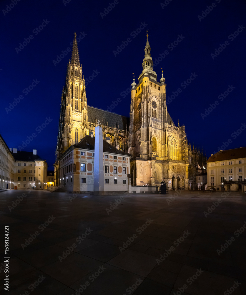 Fototapeta premium St. Vitus Cathedral illuminating Prague Castle at night in Czechia