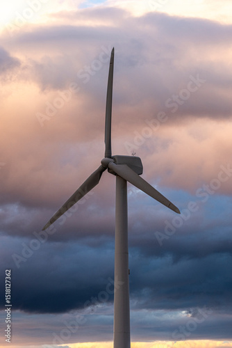 Wind turbine in Aragon Spain framed by dramatic clouds showing the harmony of technology and nature