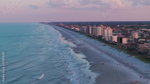 Aerial view of the Jacksonville Beach Pier in north Florida during a summer sunset.