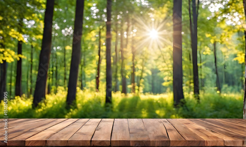 Wooden table for product presentation in nature. Selective focus on wooden table top on green landscape background. Wooden table for products against natural background in defocus.