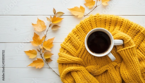 Cozy Autumn Scene: Coffee, Sweater, and Fall Leaves on White Wooden Table