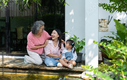 A multigenerational family gathers at home, sharing love and happiness in a heartfelt portrait. The mother and daughter cherish childhood memories together, strengthening their bond across generations