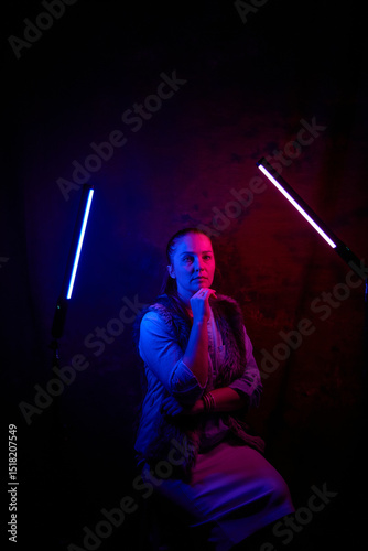 portrait of a beautiful woman in a dark room under rgb lamps