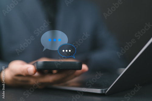 Business Woman typing on smartphone chatting conversation in chat box icon pop up for social media marketing technology concept. Live Chat Chatting on application.