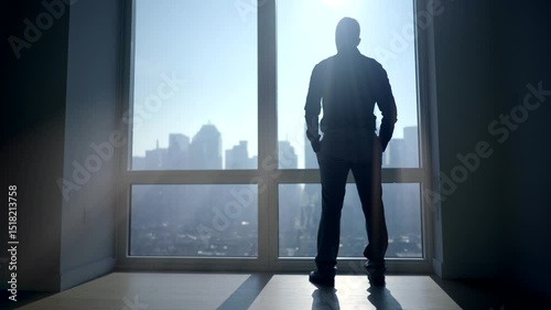 The Man is Opening the Blinds inside the Office