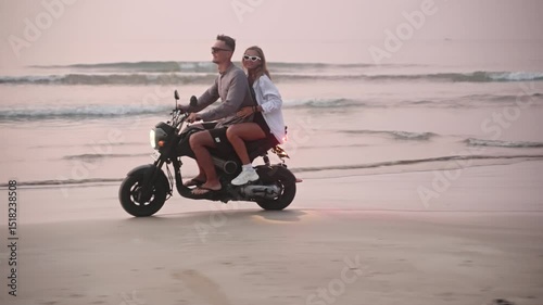 Wallpaper Mural Travel couple riding motorbike on ocean sandy beach in tropical paradise at sunset. Man with girlfriend driving motorcycle on coastline shore water edge. Woman enjoys adventure with her lover. Torontodigital.ca