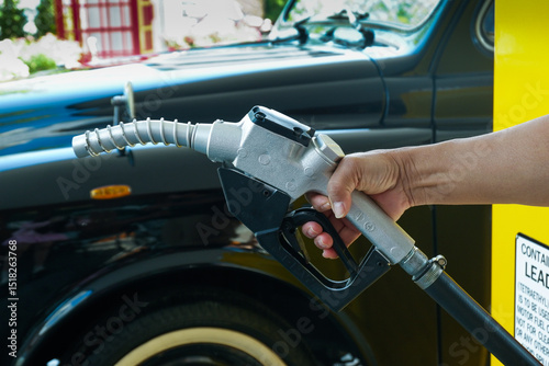 Close up fuel nozzles at gas station,Petrol pump filling fuel nozzle in gas station,Fuel Pump,Gas Station,Gasoline,service station,The concept of fuel energy.