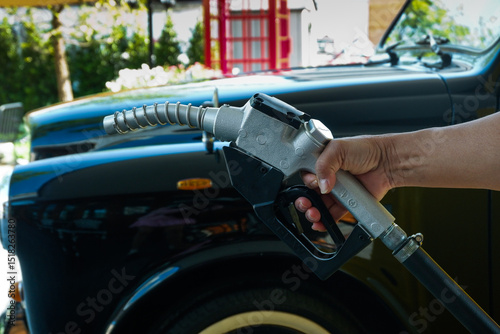 Close up fuel nozzles at gas station,Petrol pump filling fuel nozzle in gas station,Fuel Pump,Gas Station,Gasoline,service station,The concept of fuel energy.