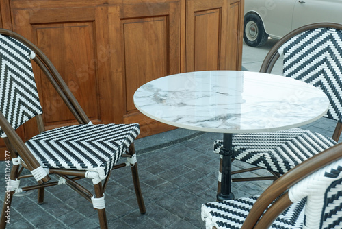 Luxury Wooden table and chair set in garden on a sunny day,outdoor seating for restaurant or cafe,Afternoon tea and drink,english style.