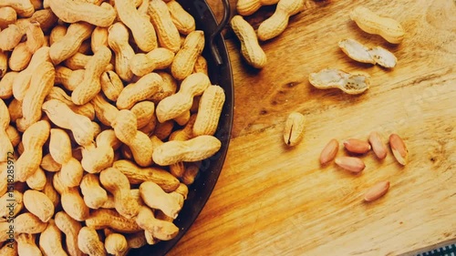 Waviness effect of Peanuts with bark on a retro tray. Peanuts cleaned in the background. Slider shooting