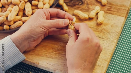Waviness effect of The woman peels the peanuts from the retro tray. Macro slider shooting