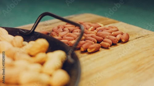 Waviness effect of Peanuts with bark on a retro tray. Peanuts cleaned in the background. Slider shooting
