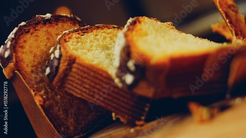 Waviness effect of Sliced chocolate panettone. In the background are Easter bunnies made of paper. Macro and slider shooting