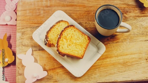 Waviness effect of The woman puts a cup of coffee on the table where there is a chocolate cake. On the background are purges of Easter made of paper. Macro and slider shooting