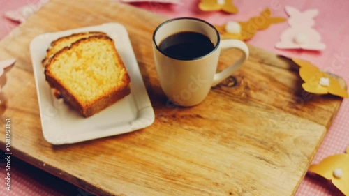Waviness effect of Cup of coffee on the table where there is a chocolate cake. On the background are purges of Easter made of paper. Macro and slider shooting