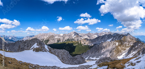 Stunning panorama view of the massif of  Tyrolean Alps from top of Hafelekarspitze peak in spring on a sunny day with blue sky, Innsbruck, Tyrol, Austria