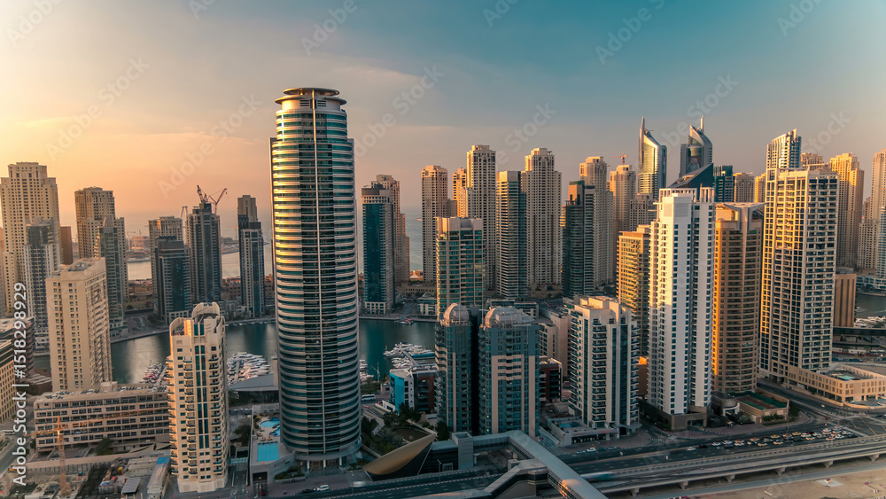 Fototapeta premium Aerial top view at sunset timelapse of Dubai Marina and JLT in Dubai, UAE