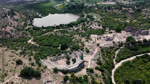 Aerial view of the ruins of the ancient city of Kaunos with tourists walking along a path in Koycegiz, Mugla, Turkey
