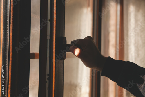 hand with open door on the window