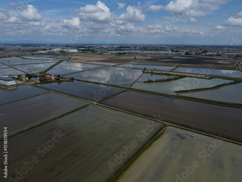 Drone view of Novara’s countryside with flooded rice fields reflecting the sky—iconic of local agricultural land use.