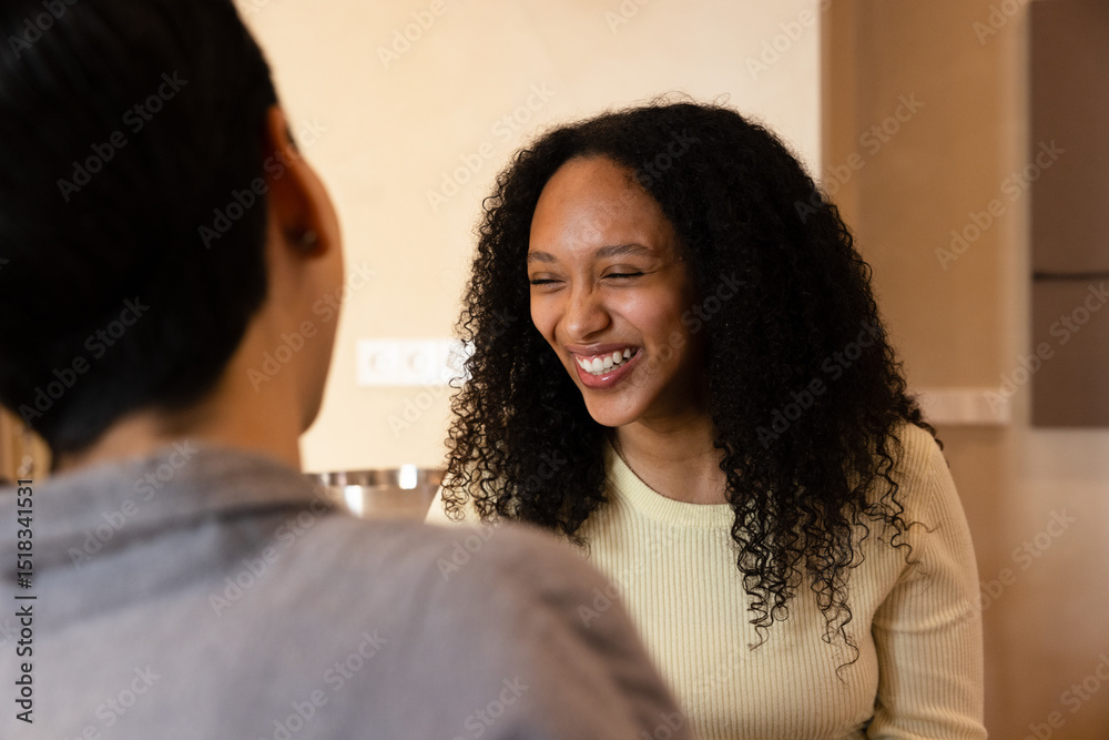 Woman smiling during friendly conversation indoors Woman smiling during friendly conversation indoors