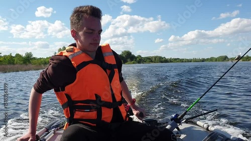 teen boy drives a motor PVC boat, fishing on trolling