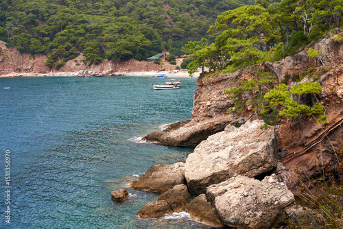Fototapeta Naklejka Na Ścianę i Meble -  10.02.2019 Kabak Beach in Turkey. Scenic coastal view with rocky cliffs and pine trees by the sea.