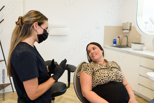 Dentist explaining treatment to patient in dental clinic