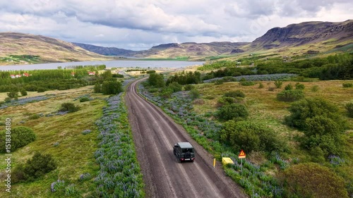 Aerial Shot Following Car Through Iceland Landscape mountains Epic Scenic Road Trip Scene.