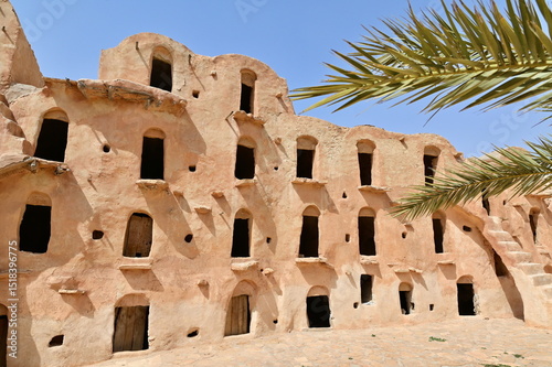 Traditional Berber Architecture at Ksar Ouled Soltane with Palm Tree in Southern Tunisia