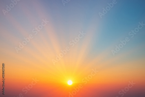 Radiant sunrise with sun rays over clear sky
