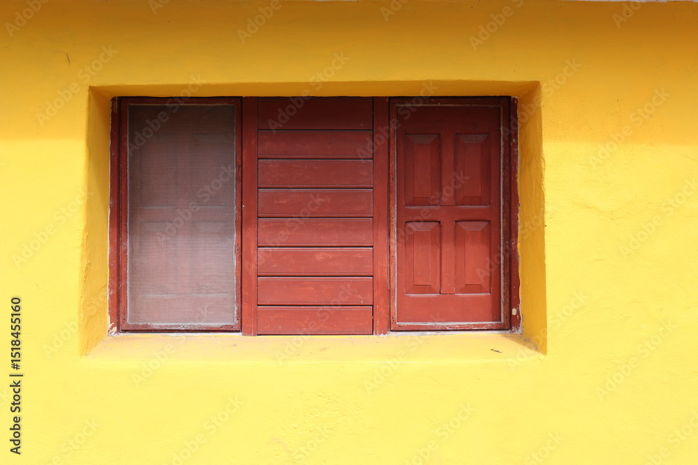 Obraz premium brown window on a yellow wall