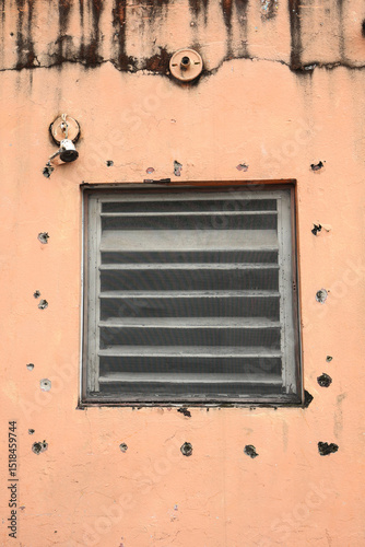 old wooden window in an orange wall