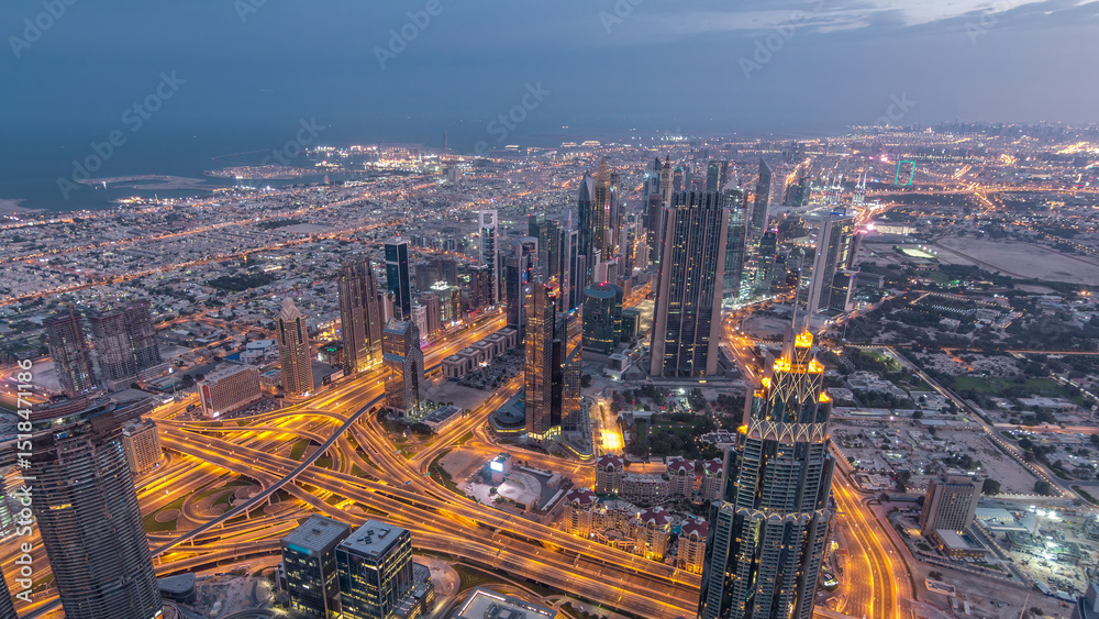Obraz premium Downtown of Dubai night timelapse before sunrise. Aerial view with towers and skyscrapers