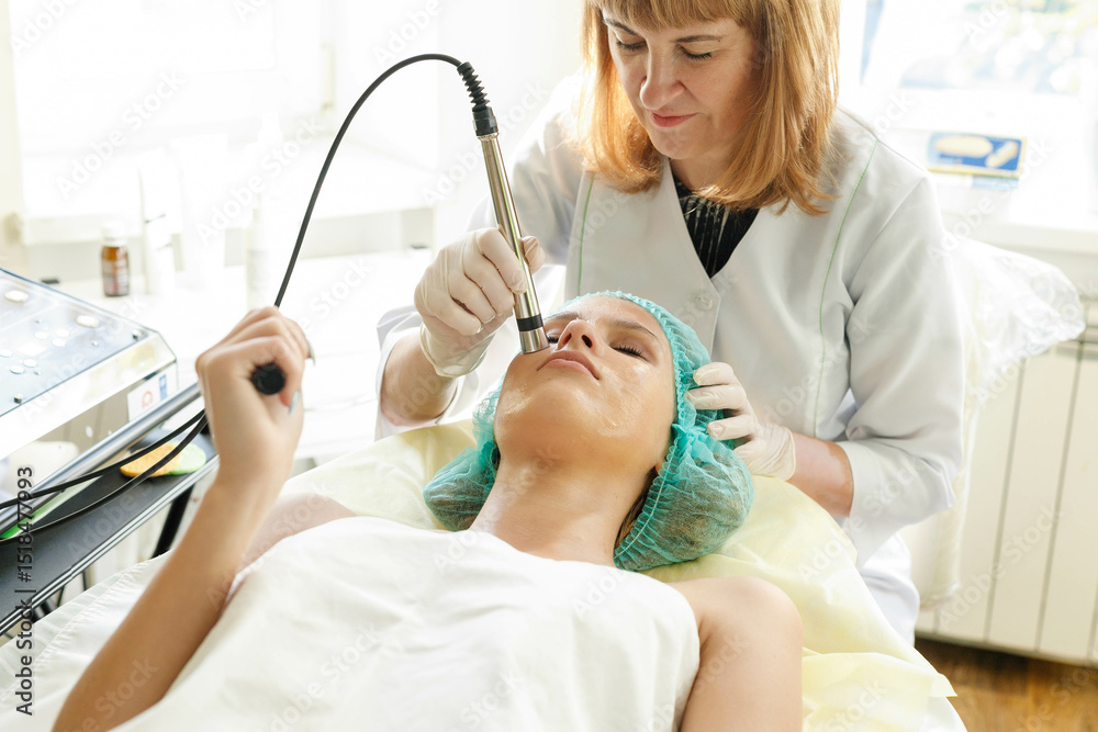 Cosmetologist makes the procedure microcurrent therapy beauty salon Cosmetologist makes the procedure microcurrent therapy beauty salon