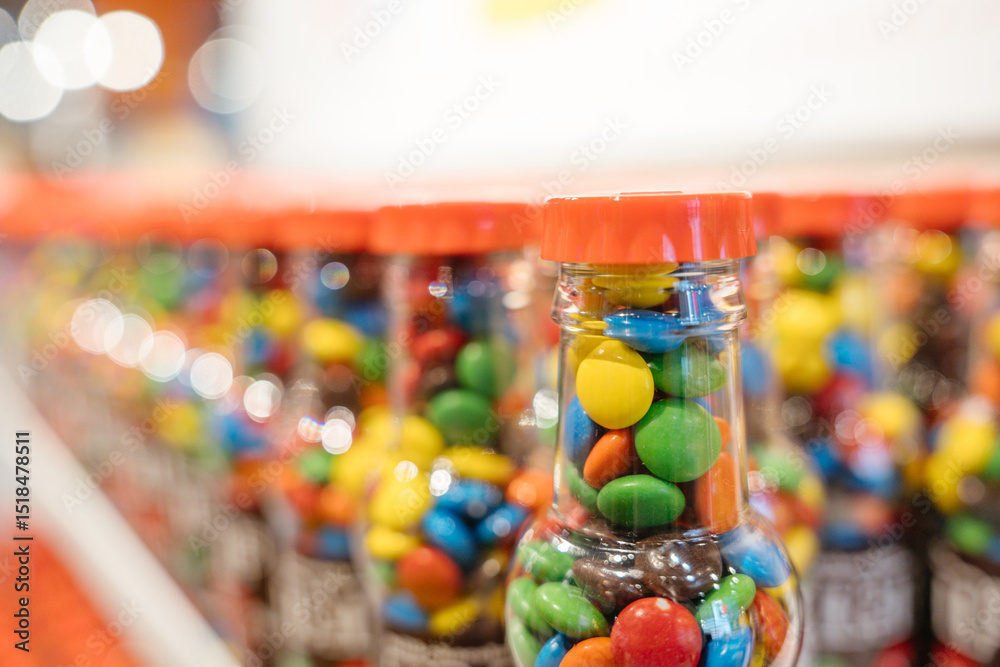 custom made wallpaper toronto digitalClear bottles filled with colorful candies line up on the shelf. The perspective creates a bokeh effect in the background.