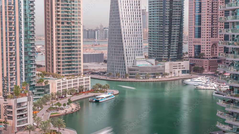 Fototapeta premium Waterfront promenade in Dubai Marina aerial timelapse. Dubai, United Arab Emirates